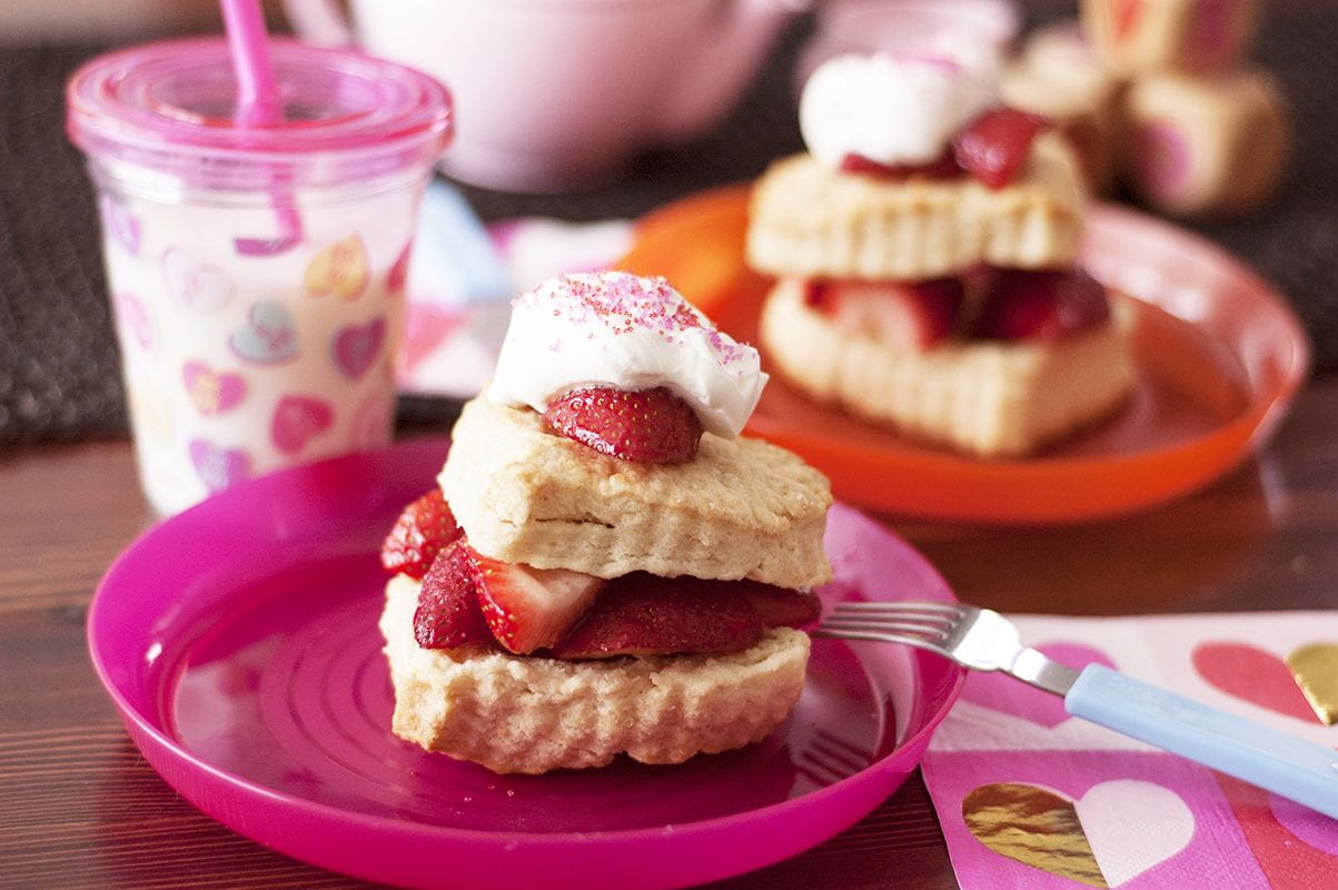 closeup heart-shaped strawberry shortcakes on plate
